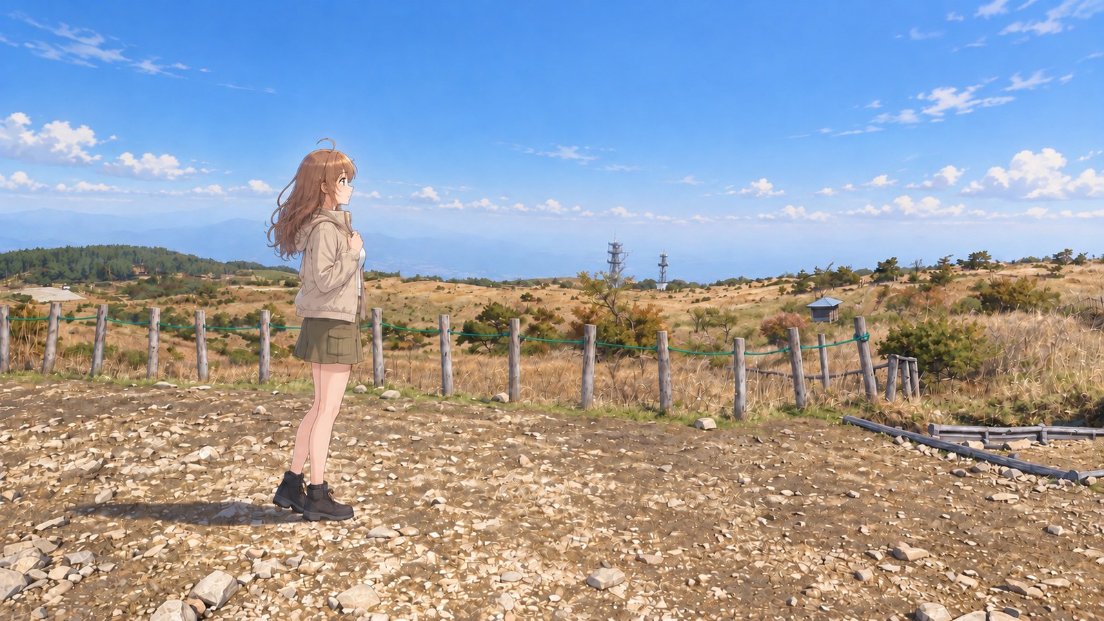 At Takabocchi Highland in spring, a woman stands in profile in a beige jacket, khaki cargo miniskirt, black tights, and boots, holding the front of her jacket with one hand. Beyond wooden posts and green rope, grassland and mountain ranges spread out.