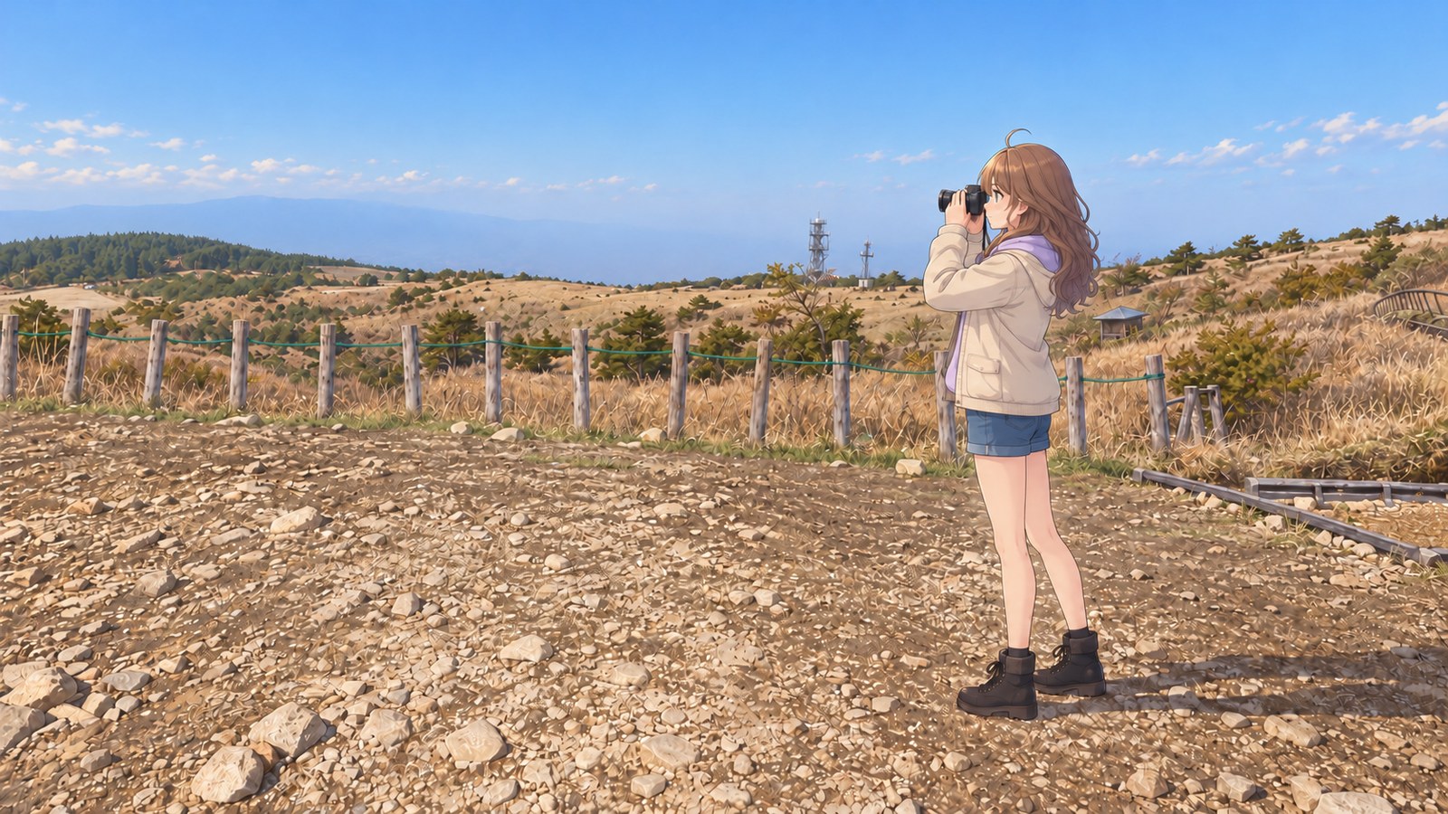 At Takabocchi Highland in autumn, a woman in a cream jacket over a lavender hoodie, denim shorts, black tights, and boots holds a camera in profile. Beyond the stone path and wooden posts, dry grassland and distant mountain ranges stretch on.