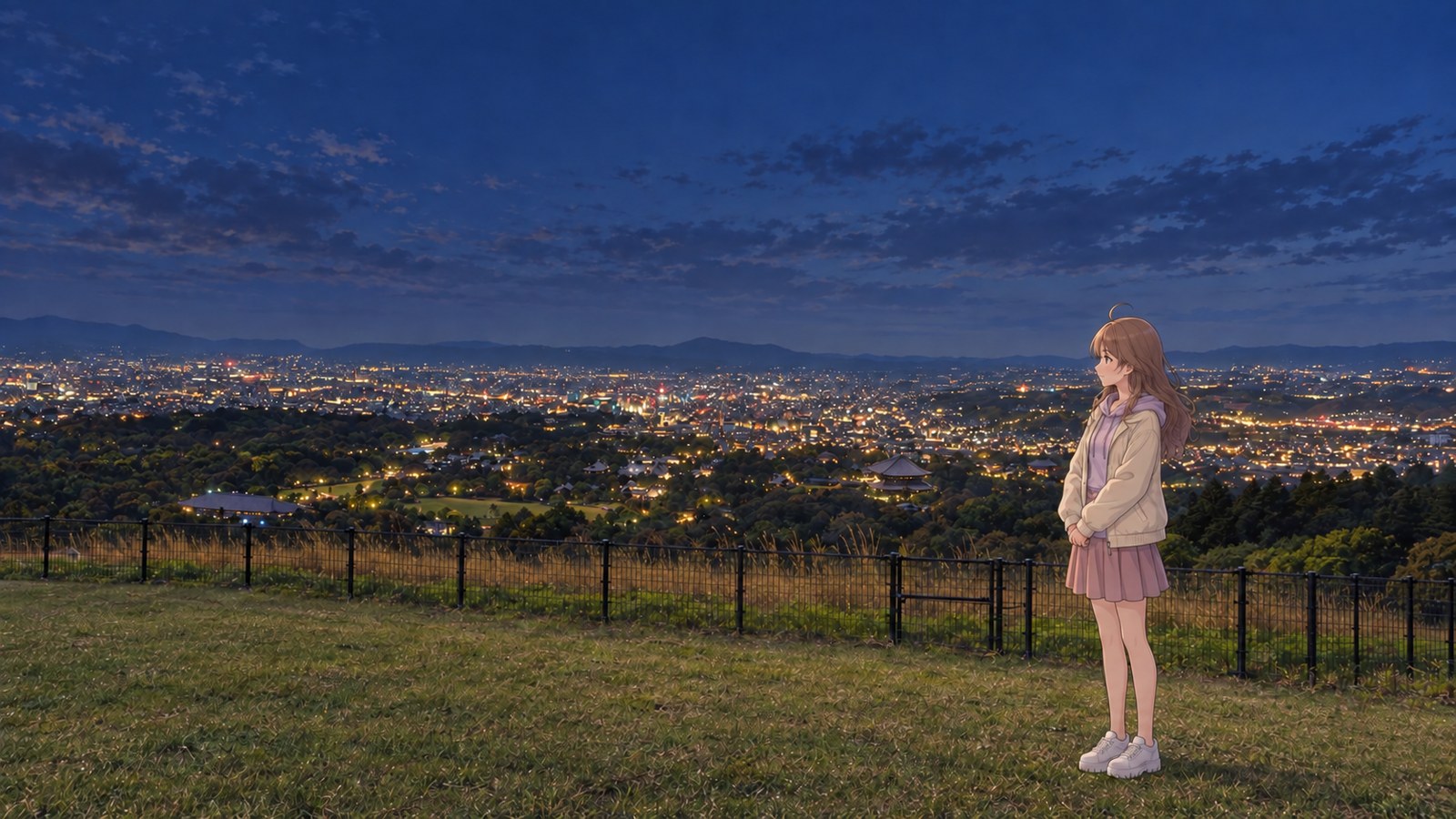At the Wakakusayama summit in early autumn, a woman in a pale top and skirt stands inside a low black railing, looking out at the night view of Nara