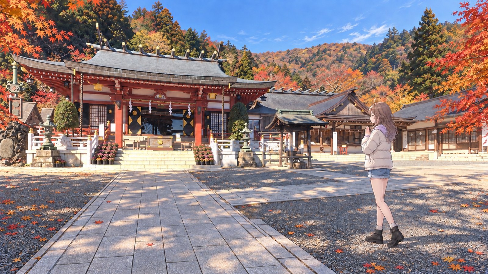 Autumn at the Lower Shrine of Oyama Afuri Shrine. To the right of the stone approach, a woman wearing a white padded jacket, pale purple hoodie, denim shorts, black tights and boots stands with her hands together facing the worship hall, whose red pillars are framed by autumn leaves.