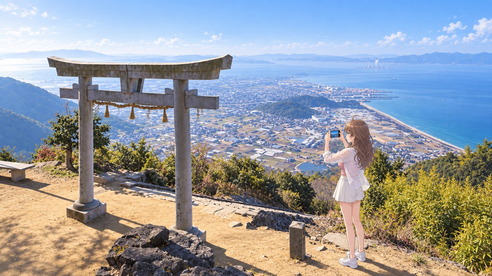 Beyond the stone torii at the main shrine of Takaya Shrine, the city of Kanonji and the Seto Inland Sea spread out below. A woman in a white shirt and miniskirt holds a smartphone horizontally.