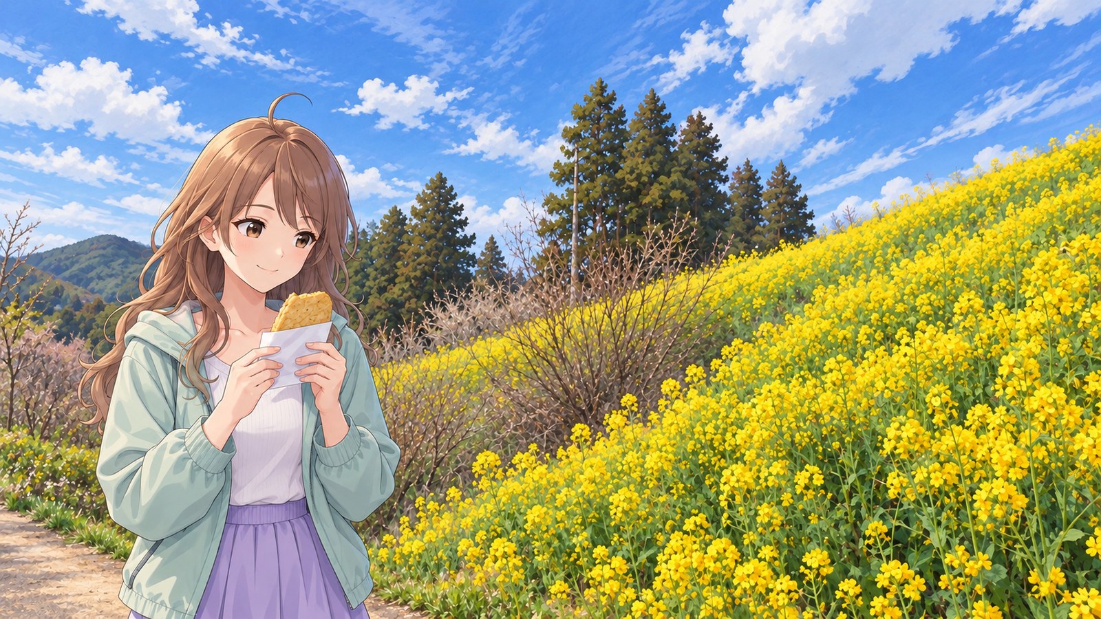 A woman smiles as she holds paper-wrapped jakoten in both hands on a path through Yellow Hill at Inuyose Pass, where rapeseed flowers are in bloom. She wears a mint jacket and lavender skirt, with cedar trees and mountain ridges behind her.
