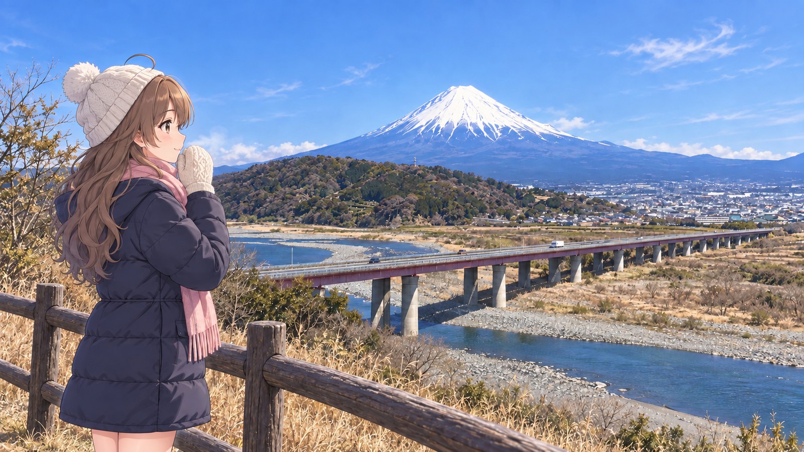 Beside a wooden railing, a woman blows on her mittened hands while gazing at snow-covered Mount Fuji beyond the Fuji River and the long bridge on the Tōmei Expressway. She's wearing a white knit cap and a pink scarf.